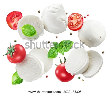 Slice and balls of mozzarella cheese, basil leaves and cherry tomatoes levitating in air on white background. File contains clipping paths.