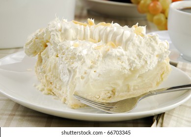 A Slice Of Banana Cream Pie Topped With Shaved Nuts