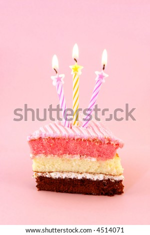 A slice of birthday cake with starry birthday candles.