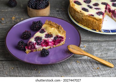 Slice Of Blackberry Pie On Wooden Background.