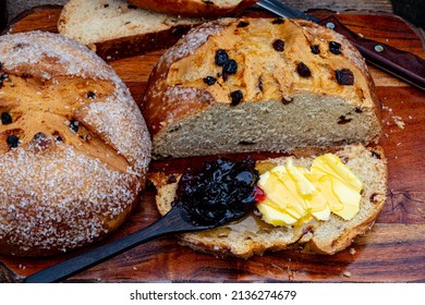 Slice Of Bread Cut From Round Loaf Of Irish Soda Bread Spread With Irish Butter And A Wooden Spoonful Of Black Cherry Jam