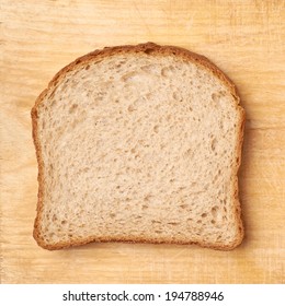 Slice of bread over the wooden surface