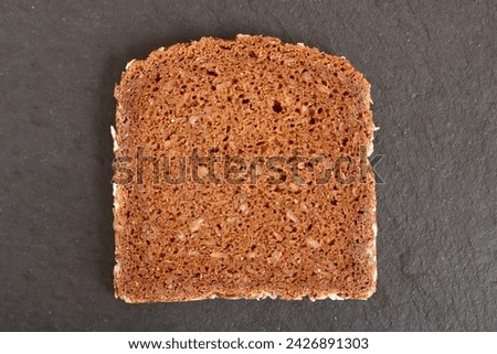 a slice of brown bread on a dark background