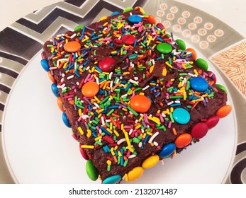 Slice cake chocolate. Colorful cake topping. Cake decorated with sugar sprinkle dots - Powered by Shutterstock