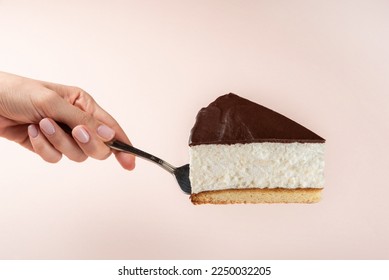 Slice of cake in hand. Hand  female holding slice of cake. isolated background. Side view. - Shutterstock ID 2250032205