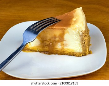 Slice Of Cheese Cake Top With Carmel And A Fork