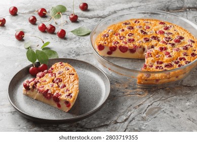 slice of cherry pie clafoutis simple summer dessert close-up in a plate on a table. Horizontal