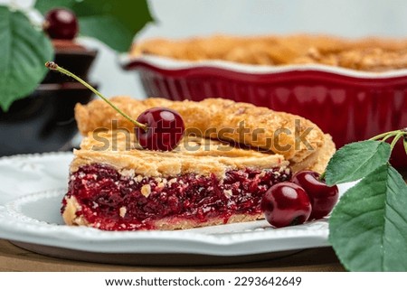 slice of cherry pie, Flaky Crust, piece on a plate and the whole homemade cherry pie, Long banner format. top view,