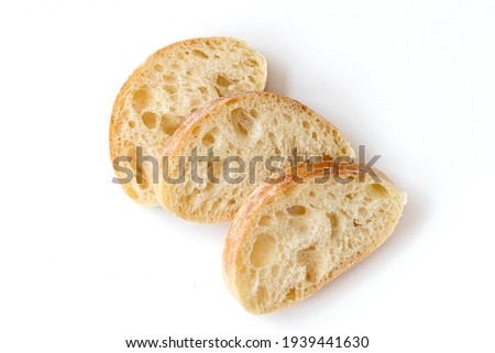 Slice of Chiabata bread isolated on white background, top view. Sliced Italian ciabatta.