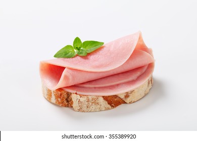 Slice of continental bread with ham