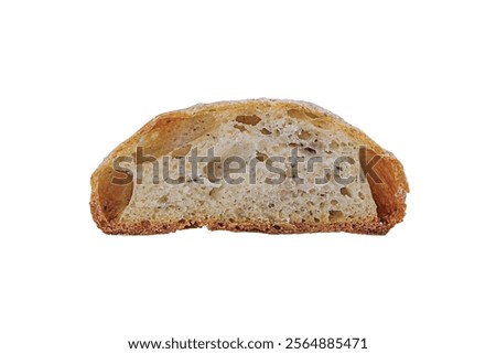 Slice of cross-cut light bread isolated on transparent white background in close-up with air bubbles of various shapes and sizes. Bottom is dark caramel with crust, top some sprinkled with flour.