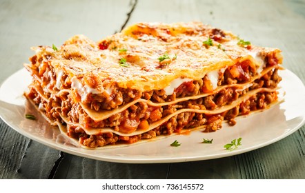 Slice Of Delicious Beef Lasagne On A Plate Garnished With Chopped Fresh Parsley And Viewed Close Up On The Side Showing The Layers