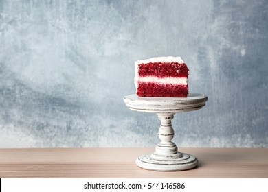 Slice Of Delicious Red Velvet Cake On Wooden Stand