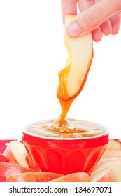 A Slice Of Fresh Apple Being Dipped Into Smooth, Buttery Caramel Dip.  Shot On White Background.