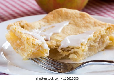 A Slice Of Fresh Apple Slab Pie On White Plate With Fork