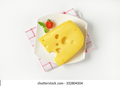 Slice Of Fresh Cheese On White Plate And Checkered Dishtowel