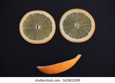 Slice Of Fresh Orange Smile Face Isolated On Black Background