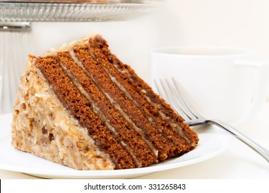 Slice Of German Chocolate Cake Closeup With Cup Of Coffee.  Isolated On White Background.