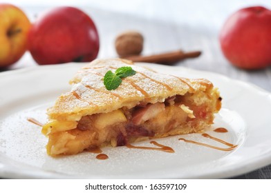 Slice Of Homemade Apple Pie With Fresh Apples On Wooden Background