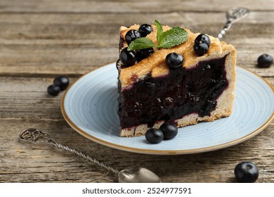 Slice of homemade blueberry pie on wooden table, closeup - Powered by Shutterstock