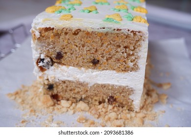 Slice Of Homemade Carrot Cake With Cream Cheese Frosting. Above View Over A Rustic White Wood Background.