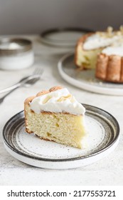 Slice Of Homemade Coconut Buttermilk Pound Cake Glazed Whipped Cream And Coconut Flakes On Gray Concrete Background. Selective Focus