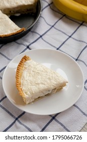 Slice Of Homemade Tasty Banana Cream Pie On A White Wooden Background, Low Angle View. Close-up.