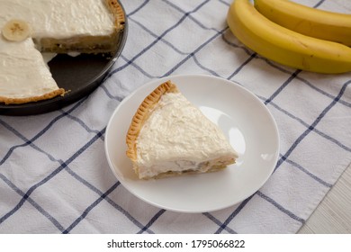 Slice Of Homemade Tasty Banana Cream Pie On A White Wooden Table, Low Angle View. Close-up.