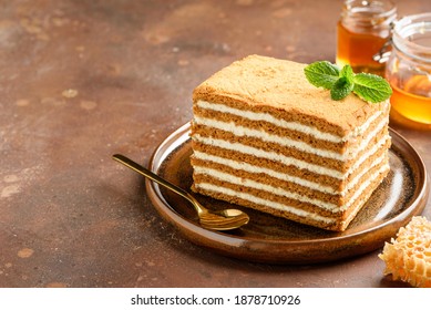 A slice of honey cake on a plate. Copy space. Selective focus