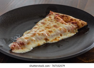 Slice Of Hot Cheese Pizza From Oven On Brown Plate