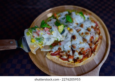 Slice of hot Homemade Pizza Topping Avocado and Macadamia With vegetables, tasty, traditional Italian fast food on classic table in side view. - Powered by Shutterstock