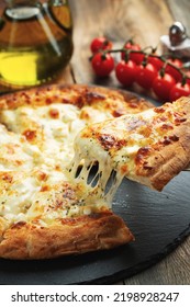 A slice of hot Italian pizza with stretching cheese. Pizza four cheeses with basil. - Shutterstock ID 2198928247