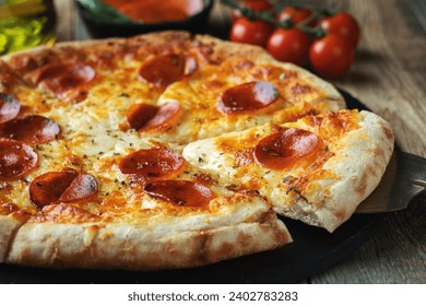 A slice of hot Italian pizza with stretching cheese. Pizza pepperoni on a dark wooden background - Powered by Shutterstock