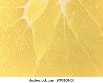 A Slice Of Juicy Fresh Yellow Aromatic Bergamot Very Close In Detail Close-up Macro. Fruit Background. Pattern. Citrus