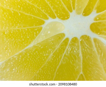 A Slice Of Juicy Fresh Yellow Aromatic Bergamot Very Close In Detail Close-up Macro. Fruit Background. Pattern. 