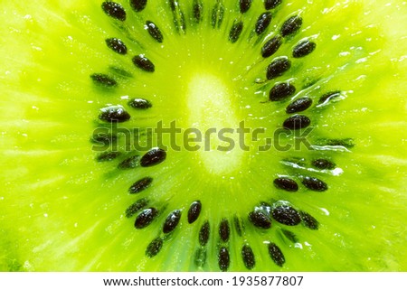 slice of kiwi fruit on a full frame. horizontal format,Fruit,Macrophotography,Vegetable,Food,Textured Effect,Textured,Nature,Extreme Close-Up,Kiwi Fruit,Freshness,Seed,Green Color,Multi Colored,Cross 