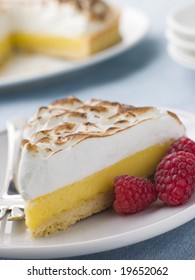 Slice Of Lemon Meringue Pie With Raspberries