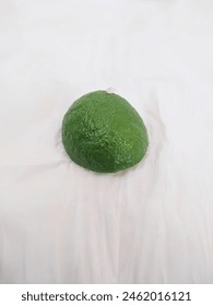 a slice of lime on a white tissue with several slices