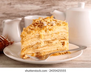 Slice of mille-feuille cake also called Napoleon cake or vanilla custard slice. Dessert made of puff pastry layered with pastry cream. - Powered by Shutterstock