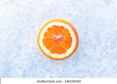 Slice Of Orange Fruit On A Crashed Ice