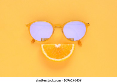 Slice Orange Fruit Sets As Smile Mouth And Yellow Sunglasses Isolated On Yellow Background For Summer Time With Space For Text.