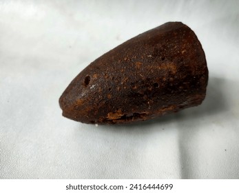 A slice of palm sugar or java sugar isolated the white background