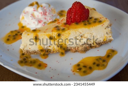 Slice of Passion Fruit Cheesecake topped with a strawberry