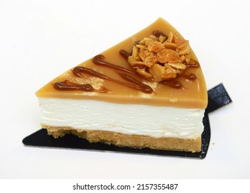 Slice Of Pecan Caramel Cheesecake Isolated On A White Background
