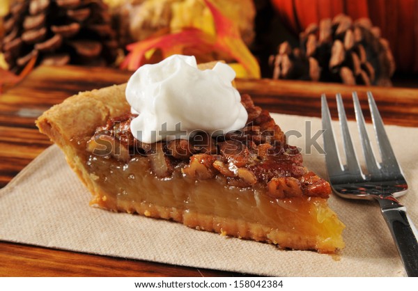 A slice of pecan\
pie on a holiday setting