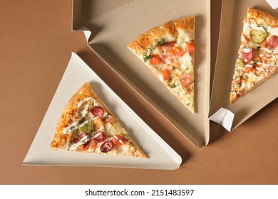 a slice of pizza in a triangle-shaped carton for serving and taking away