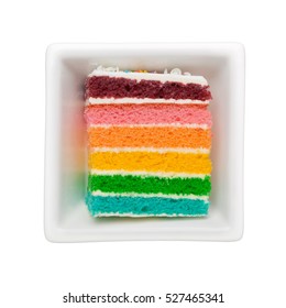 Slice Of Rainbow Cake In A Square Bowl Isolated On White Background
