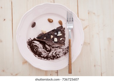 A Slice Of Raw Vegan Snickers Cake On A White Plate Ready To Eat It.