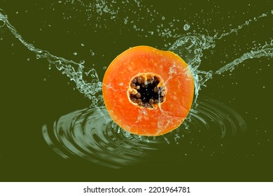 Slice Of The Ripe Papaya Fruit With Splashing Water Isolated On Green Background With Clipping Path