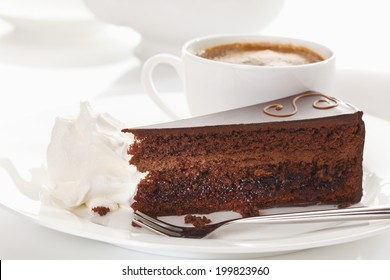 Slice Of Sacher Cake In Plate With Coffee